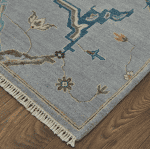 Elegant Bhatia 6561F blue and multi-colored area rug with floral and geometric patterns.