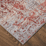 Elegant area rug with a distressed pattern in blue and red tones.