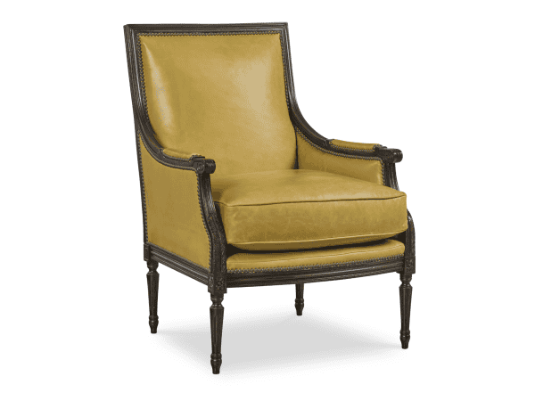 Luxurious mustard yellow upholstered armchair with dark wooden carved frame, nailhead trim, and elegant tapered legs, perfect for classic or vintage interior decor.
