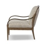 Soft beige upholstered accent chair with wooden and metal armrests, featuring amid-century modern design perfect for living rooms and lounges.