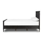 Black wooden twin bed frame with a classic design and white mattress and pillow included. Perfect for a charming bedroom setting in Tyler, Texas.