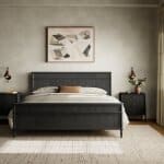 Sleek black wooden bed frame with matching nightstands, neutral bedding, and modern artwork above, creating a stylish and cozy bedroom setting in Tyler, Texas.