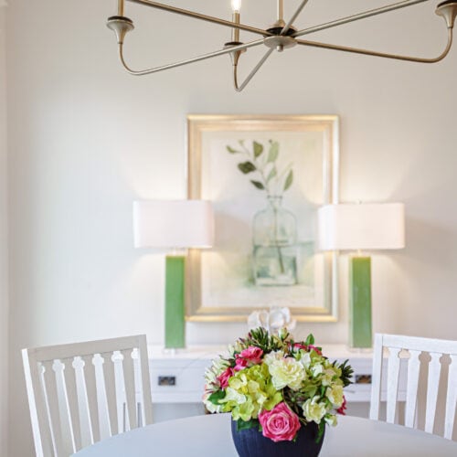 Elegantly Furnished Dining Room Featuring A White Table With A Colorful Floral Centerpiece, Modern Chandelier, And Decorative Lamps In A Bright, Inviting Space At Swann'S Furniture &Amp; Design In Tyler, Texas.