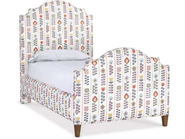 Vibrant floral patterned upholstered bed with a tall, ornate headboard and curved footboard, featuring wooden legs, ideal for a stylish bedroom decor.