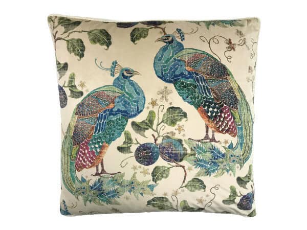 Colorful embroidered cushion featuring vibrant blue peacocks with intricate feather details, surrounded by green leaves, small flowers, and fruit on a light background.