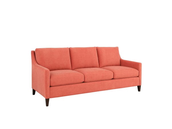 Soft Coral Upholstered Sofa With Three Cushions, Wooden Legs, Modern Design, Perfect For Living Rooms And Lounges.