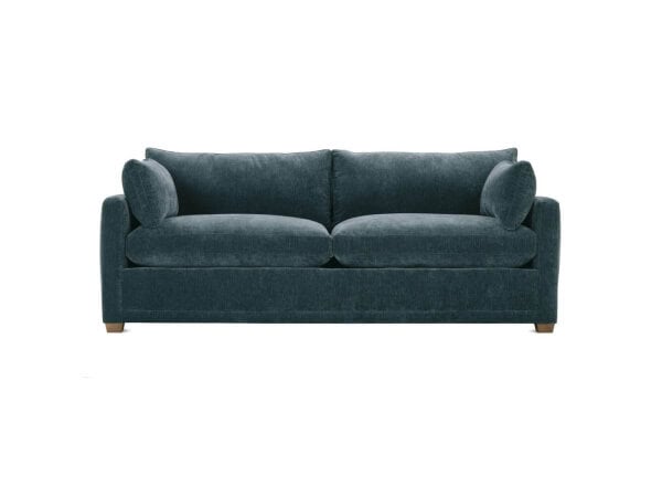 Elegant navy blue fabric sofa with plush cushions and rolled arms, perfect for living rooms or family spaces, available at Swann's Furniture & Design in Tyler, Texas.