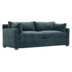 A plush, deep blue upholstered sofa with comfortable cushions and wide armrests, perfect for living room relaxation. Sturdy wooden legs add stability and elegance to the overall design.