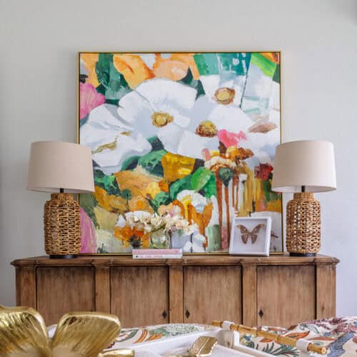 Elegant Floral Artwork With Vibrant Colors Displayed Above A Wooden Sideboard.