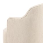 Elegant beige upholstered London dining chair with a curved backrest and wooden legs, perfect for stylish dining rooms.