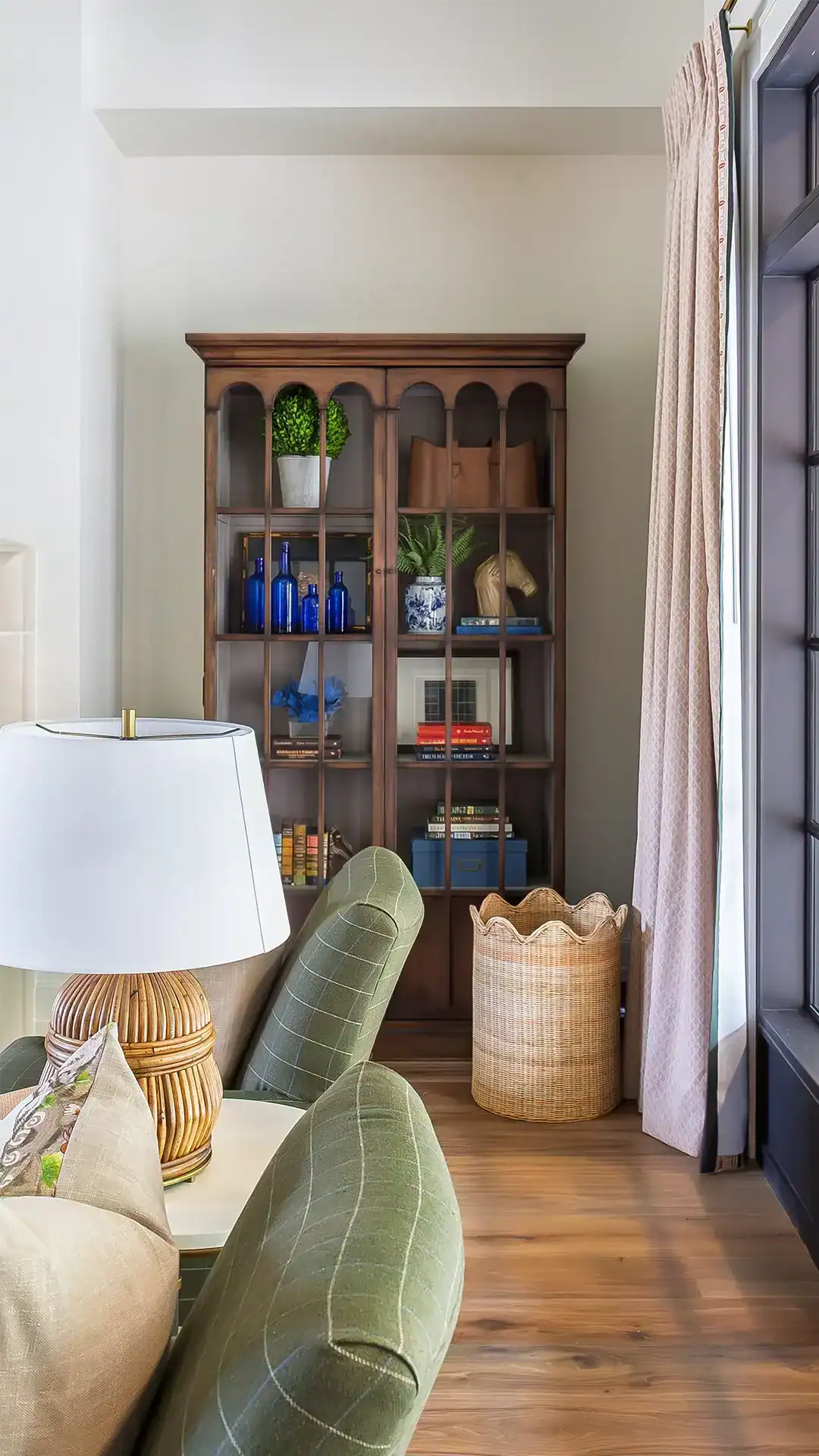 Classic Wooden Bookcase With Decorative Items And Books In A Cozy Living Room Setting.
