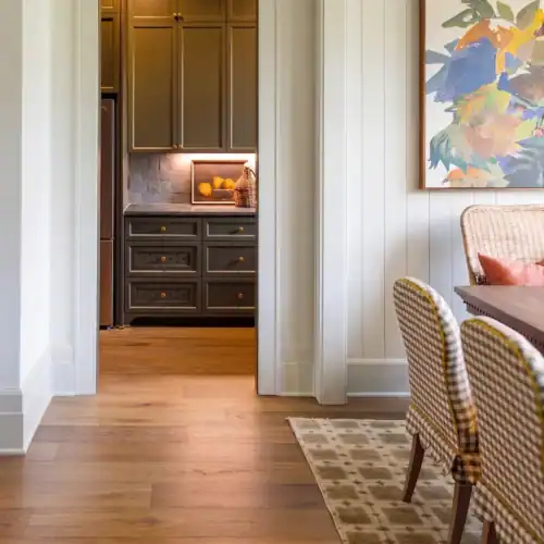 Bright And Inviting Dining Area Featuring Patterned Chairs, A Wooden Floor, And Colorful Artwork On The Wall, Creating A Warm And Stylish Atmosphere.