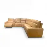Comfortable tan leather sectional sofa with chaise lounge and built-in side table, perfect for living rooms and family spaces.