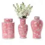 Pink floral ceramic vases with white flower patterns, perfect for decorating living spaces or as gifts.