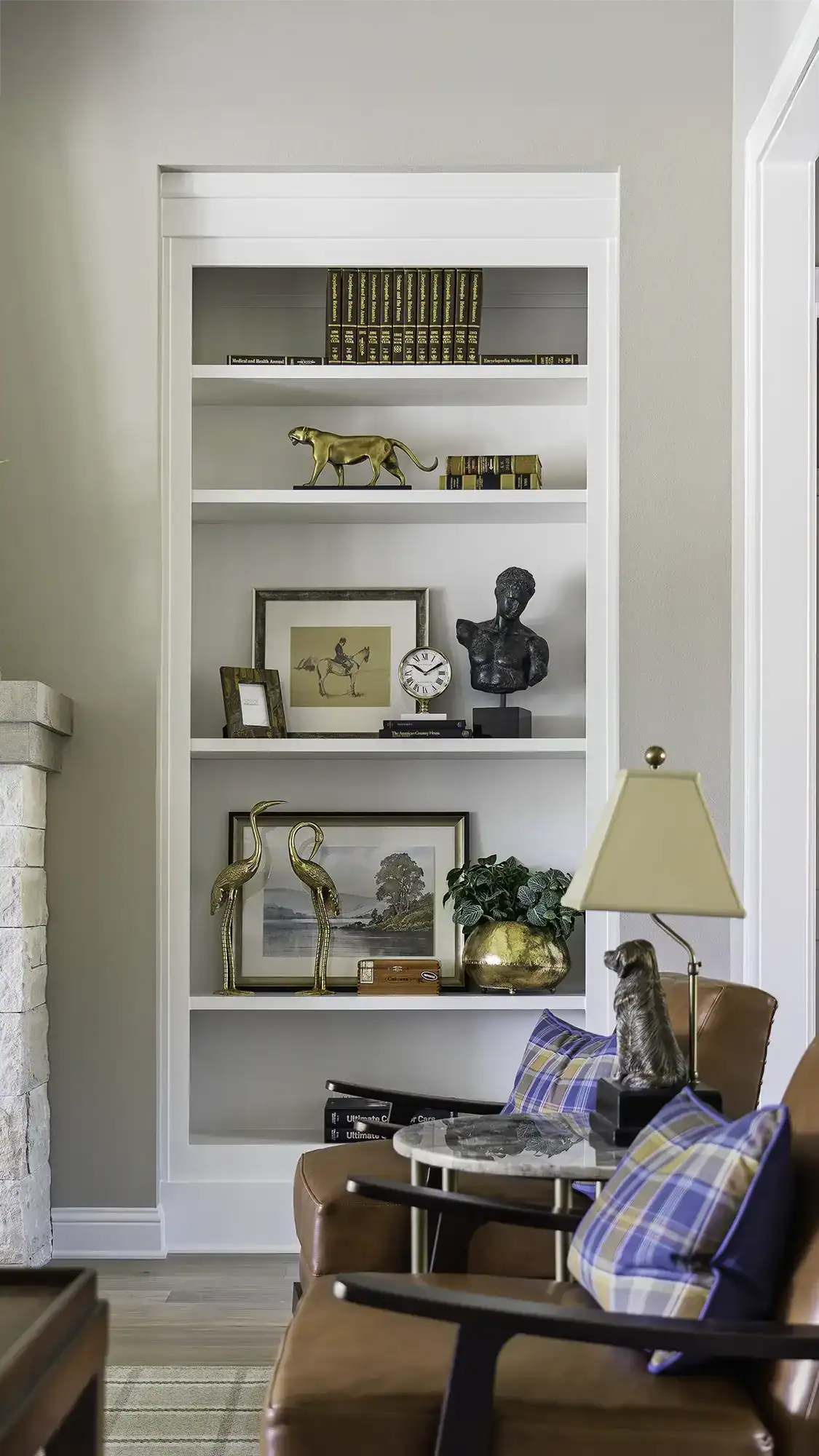 Stylish White Bookcase Filled With Books, Decorative Items, And Artwork In A Cozy Living Room Setting In Tyler, Texas.