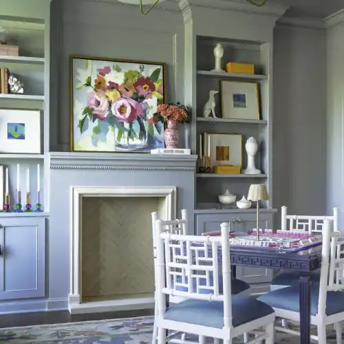 Stylish Dining Room Featuring A Blue And White Color Scheme, Modern Chandelier, And Colorful Floral Artwork, Perfect For Home Decor Inspiration.